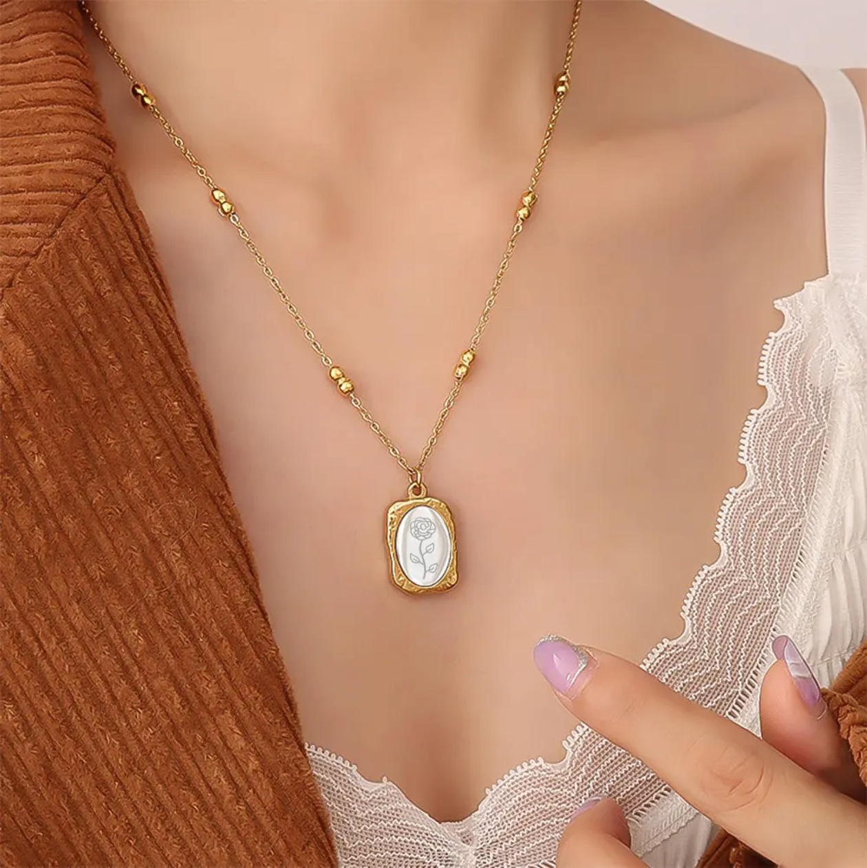 Gold necklace with a pendant on a mannequin